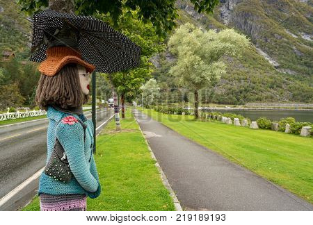 EIDFJORD, NORWAY - 21 SEPTEMBER 2017: Knitted woolen female on tree trunks in Eidfjord in Norway