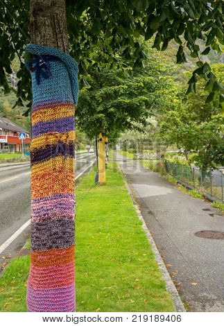 EIDFJORD, NORWAY - 21 SEPTEMBER 2017: Knitted woolen coverings on tree trunks in Eidfjord in Norway