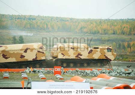 Nizhniy Tagil, Russia - September 25. 2013: Tracked carrier DT-30P1 on demonstration range. It leaves after overcoming of water ford. Russia Arms Expo-2013 exhibition