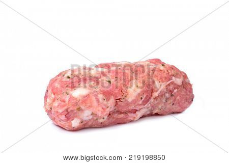 a raw pilota, a long meatball typical of Catalonia, Spain, usually added to the traditional escudella soup, on a white background