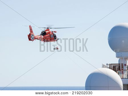 NORTH ATLANTIC OCEAN-DECEMBER 12, 2017: The United States Coast Guard engages in a medical rescue from a ship in the North Atlantic Ocean.