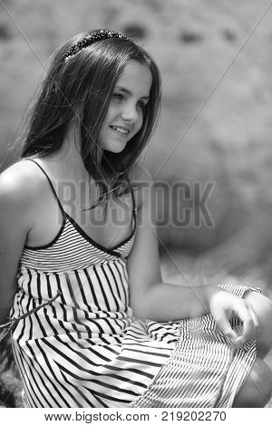 Teen teenage youth lifestyle. Girl teenager happy smile with long hair in summer dress outdoor. Fashion style concept. Beauty look hairstyle black and white