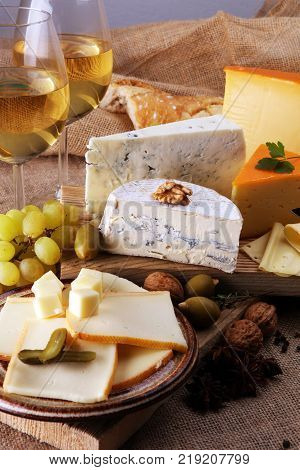 various types of cheese on rustic wooden table