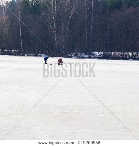 Winter fishing. River, lake near forest in ice. Anglers, Fishermens during your favorite leisure time. With place for your text, for square background