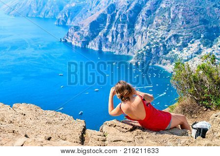Woman taking photos of beautiful scenery at Path of Gods at Tyrrhenian sea Amalfi coast Italy