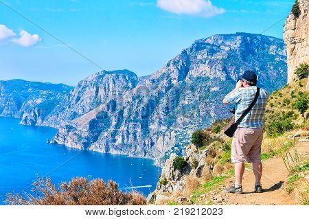 Man taking photos of beautiful scenery at Path of Gods Tyrrhenian sea Amalfi coast Italy