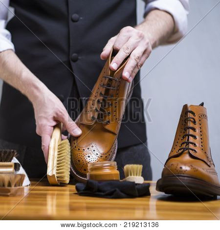Footwear Concepts. Closeup of Mans Hands Cleaning Luxury Calf Leather Brogues with Special Accessories And Tools. Square Image