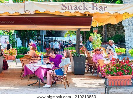 Ravello Italy - October 2 2017: People at street restaurant on central square in Ravello village Tyrrhenian sea Amalfi coast Italy