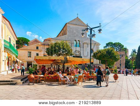 Ravello Italy - October 2 2017: People at street cafe on central square in Ravello village Tyrrhenian sea Amalfi coast Italy