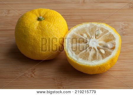 Fresh yellow whole and half Japanese Yuzu fruit