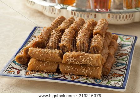 Traditional festive Moroccan cookies with sesame seeds and mint tea