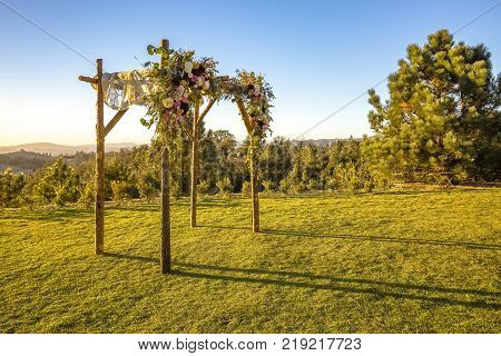 Outdoor sunset view of a Jewish traditions wedding ceremony. Wedding canopy chuppah or huppah .