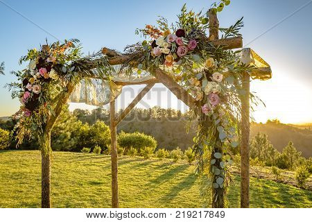 Outdoor sunset view of a Jewish traditions wedding ceremony. Wedding canopy chuppah or huppah .
