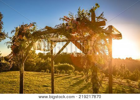 Outdoor sunset view of a Jewish traditions wedding ceremony. Wedding canopy chuppah or huppah .