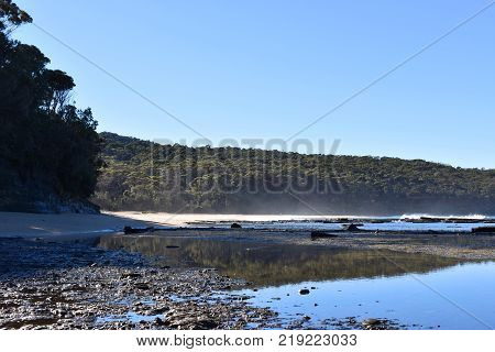 A landscape shot of the beach with cliffs
