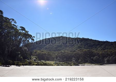 A beautiful Australian beach looking inland at a mountain