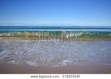 A wave mid-break in a tropical ocean