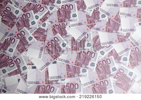 Close up background photo Amount of Five hundred notes of European Union Currency. Many pink 500 euro banknotes are adjacent. Symbolic texture photo for wealth