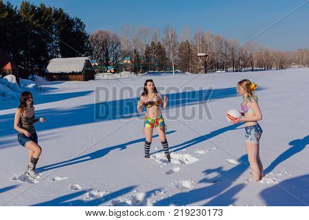 Novokuznetsk, Kemerovo region, Russia-23 Feb, 2017: White beaches of Siberia is an enterteiment activity where people playing beach games dressed in bikini in winter. Women playing volleyball on snow