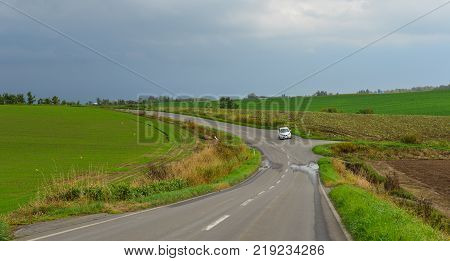 Hokkaido Japan - Oct 2 2017. A car running on rural road in Hokkaido Japan. Hokkaido is the second largest island of Japan and the northernmost prefecture.