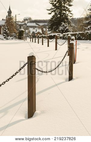 Beautiful village in winter snow cover over all road tree roof's house and church village in europe with light soft and white sky.
