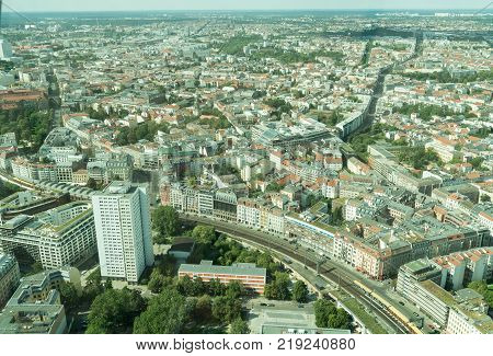 BERLIN GERMANY - AUGUST 28 2017; ciryscape with S-Bahn commuter rail-line snaking through the cityscape viewed from the Fernesturm TV tower.