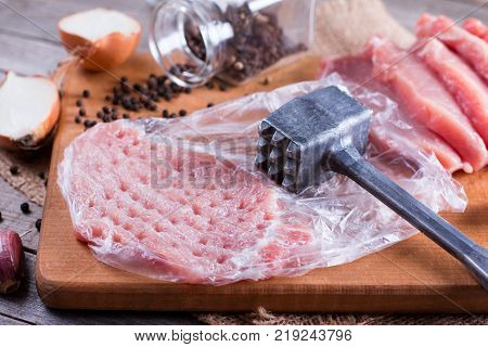 Raw chops on a cutting board on wooden desk