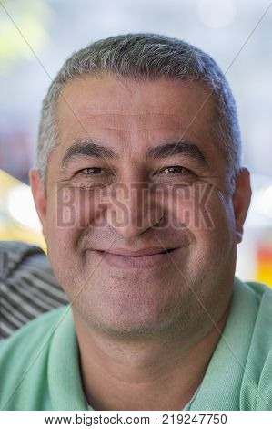 KEMER TURKEY - OCTOBER 18 2017 : Editorial photo . Portrait of a Turkish man which sells fruits and vegetables at a local bazaar. Close up