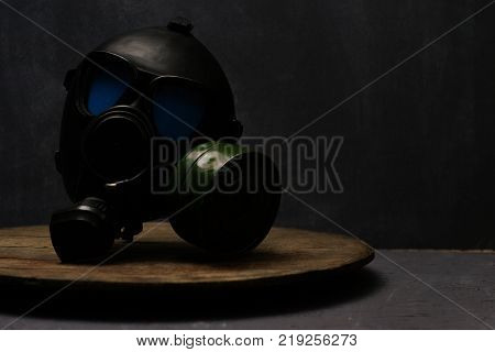 Black gas mask with blue eyes in glass on a beautiful background.