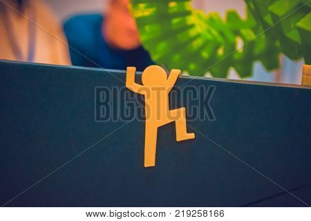 Abstract object in form of little men of yellow color printed on 3d printer close-up. Fused deposition modeling, FDM. Progressive modern additive technology. Concept of 4.0 industrial revolution