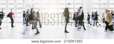 View of blurred crowd on a exhibition with trade fair booths. copyspace for your individual text.