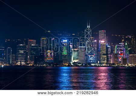 Hong Kong - December 9 2017. New year and Christmas skyline shines landmark at Victoria harbour night scene with fog in Hong Kong winter festival. Hong Kong has one of the world's most festive Christmases and New year count down