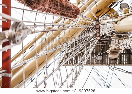 Detailed closeup of mast rigging on sail boat during cruise. Marine objects concept.