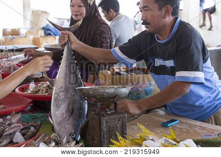 Labuanbajo Indonesia - August 18 2015: Photo from traditional exotic tribal market in Indonesia Fish seller Indonesia