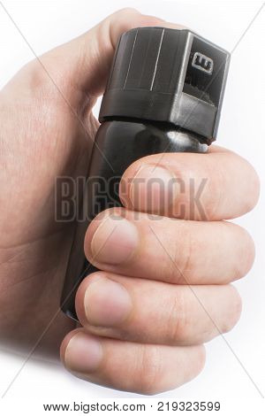 Hand with bottle of pepper spray in eyes, isolated on white background