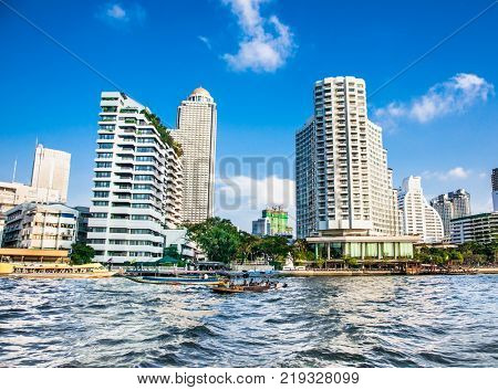 Business district cityscape from Chao Phraya River in Bangkok Thailand.
