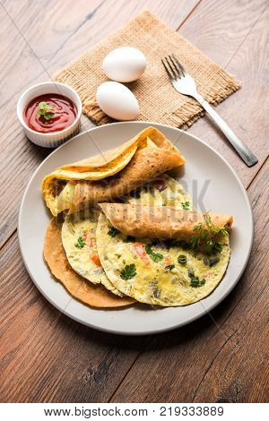 omelette / omelette chapati roll or Indian bread or roti rolled with omlet. Popular, quick and healthy recipe for kid's tiffin or lunch box