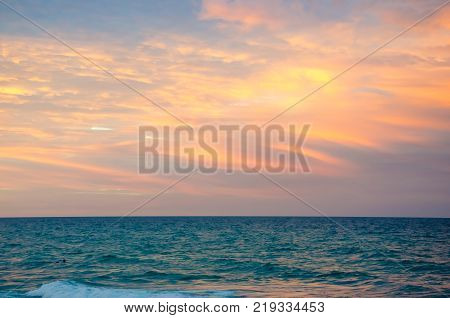 Sunset At The Beach With Tourists Enjoying