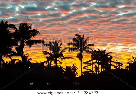 Sunset At The Beach With Tourists Enjoying