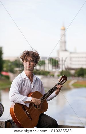 Guitar romantic man city musician concept. Playing stringed instruments lessons. Lifestyle of talented people.