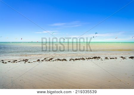 Sunset At The Beach With Tourists Enjoying