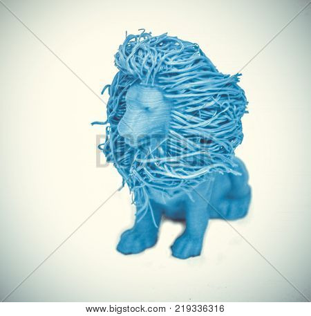 Objects printed by 3d printer Isolated on white background. Bright colorful object. Toy lion of blue color. Automatic three dimensional 3d printer performs plastic modeling in laboratory.