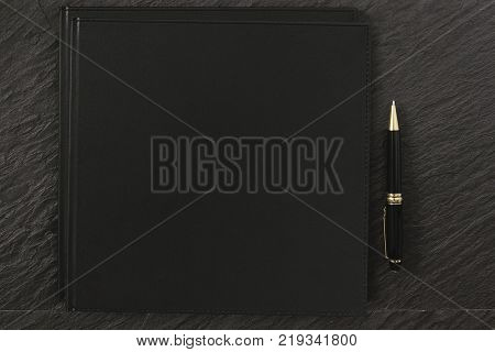 Blank Black Notebook Cover black rock table with clipping path on notebook for mockup designs