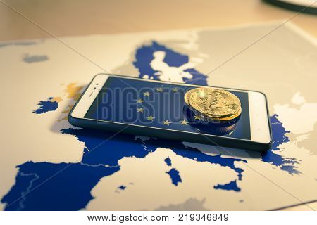 Financial concept with golden Bitcoin over smartphone, UE flag and map. Situation of Bitcoin and other cryptocurrencies in European Union concept. Warm mood