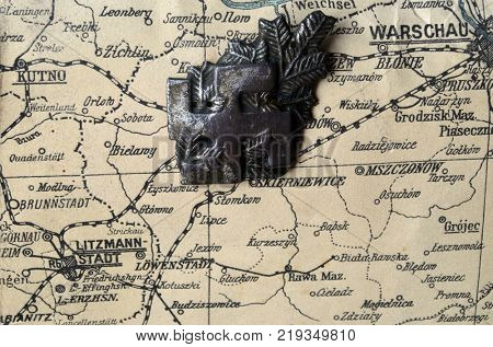 ILLUSTRATIVE EDITORIAL.Polish Army insignia (found with metal detector near Kiev).German vintage map of Central Europe circa 1944 fragment.Poland under occupation.
Kiev,Ukraine December 22 ,2017