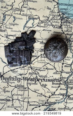 ILLUSTRATIVE EDITORIAL.Polish Army insignia (found with metal detector near Kiev).German vintage map of Central Europe circa 1944 fragment.Poland under occupation.
Kiev,Ukraine December 22 ,2017