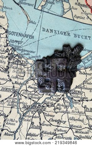 ILLUSTRATIVE EDITORIAL.Polish Army insignia (found with metal detector near Kiev).German vintage map of Central Europe circa 1944 fragment.Poland under occupation.
Kiev,Ukraine December 22 ,2017