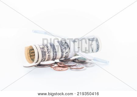 Shoestring budget concept with coins and banknotes close up