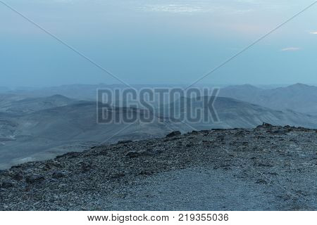 Mystic blue morning landscape view on negev judean desert in Israel. History location object in antient place. Rocks sand mountains and sunrise