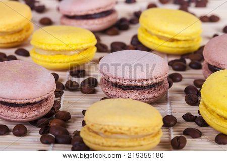 macarons with coffee flavor and coffee beans on white background